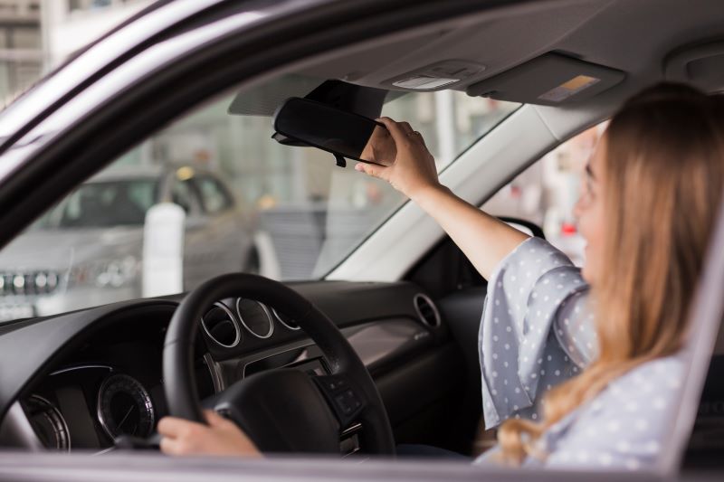 woman-arranging-rear-view-mirror.jpg